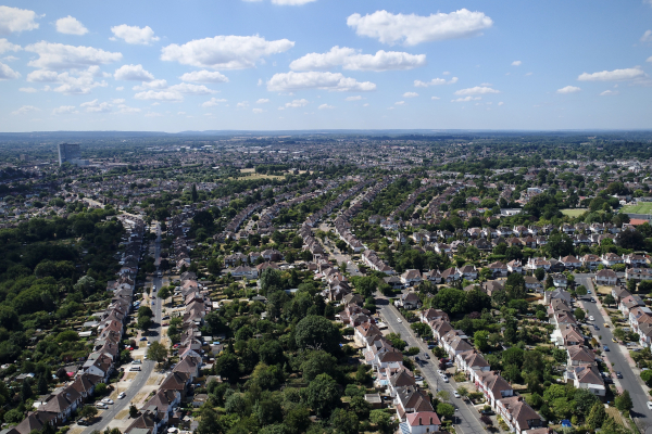 a panoramic shot of a coastal town under blue skies
